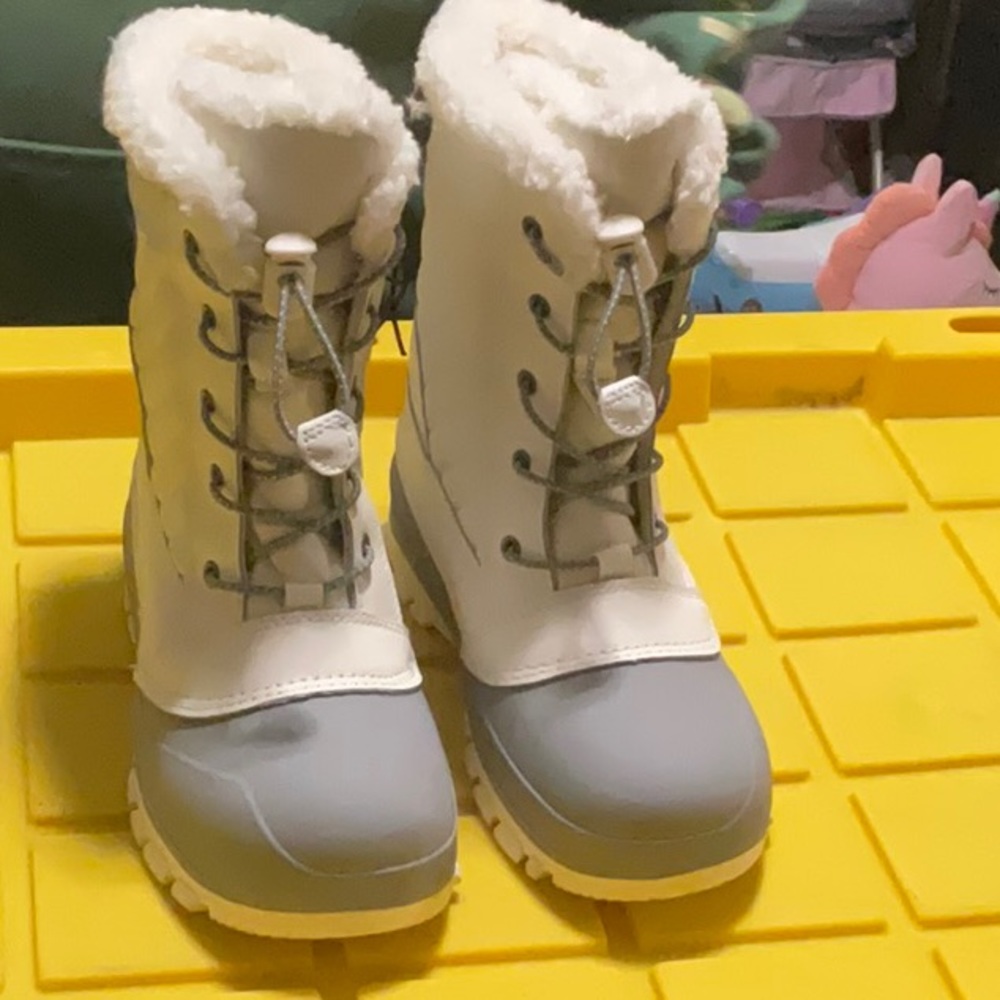 Brand new cream,  snow boots all in motion
